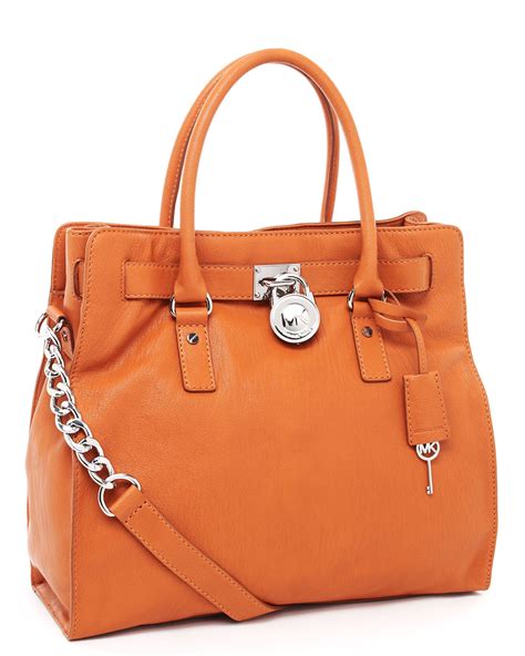 michael kors orange bag spikes green embellishment|Michael Kors orange bag.